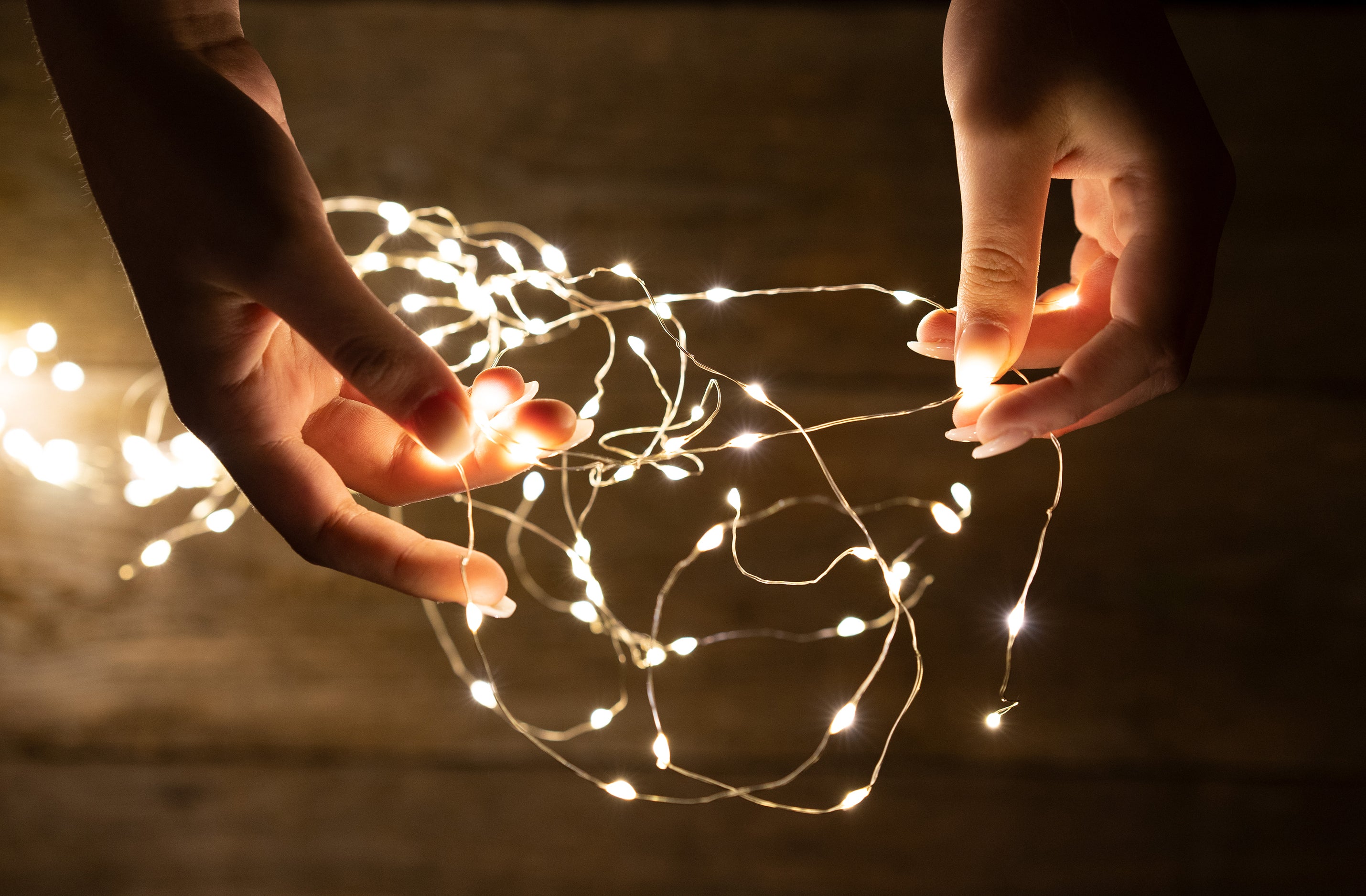 person holding string lights 